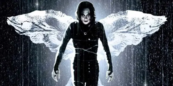 Goth model with butterfly wings in the rain, showcasing dark fashion and artistic style.