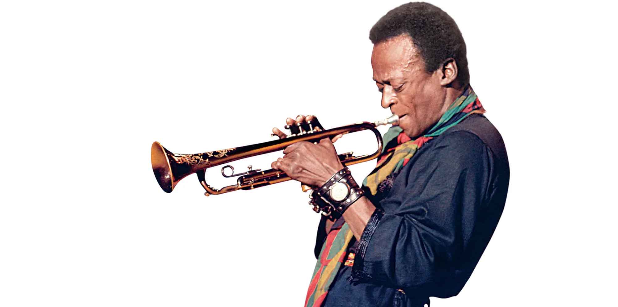 Jazz musician playing trumpet with focus and passion on a white background.
