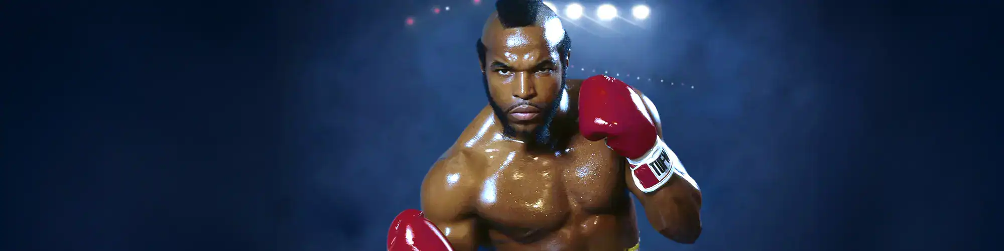 Athletic male boxer ready to fight inside the boxing ring, wearing red gloves, focused and determined.