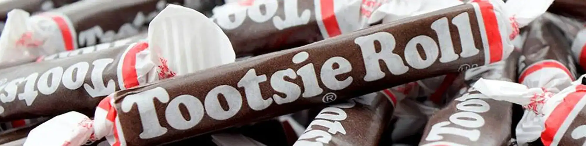Sweet, chewy Tootsie Roll candies wrapped in bright packaging, iconic American candy.