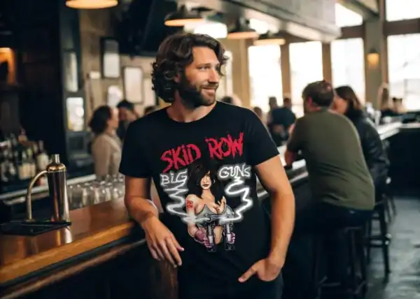 A man in a vintage rock band t-shirt enjoying drinks at a lively bar scene.