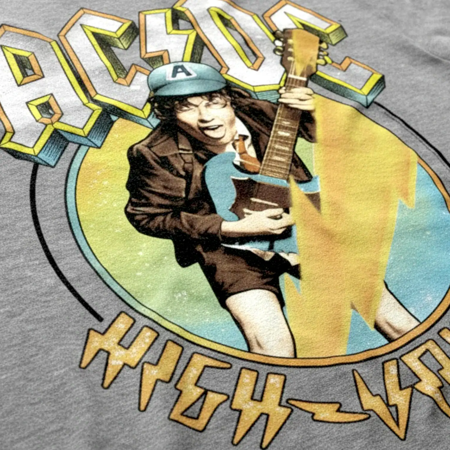 Vintage-style rock band graphic with guitar and lightning on SocieTees T-shirt.