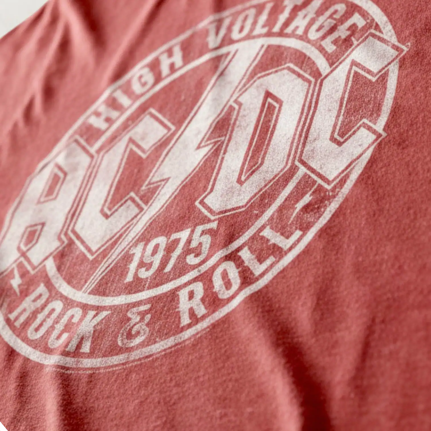 AC/DC band logo on red T-shirt, vintage style.