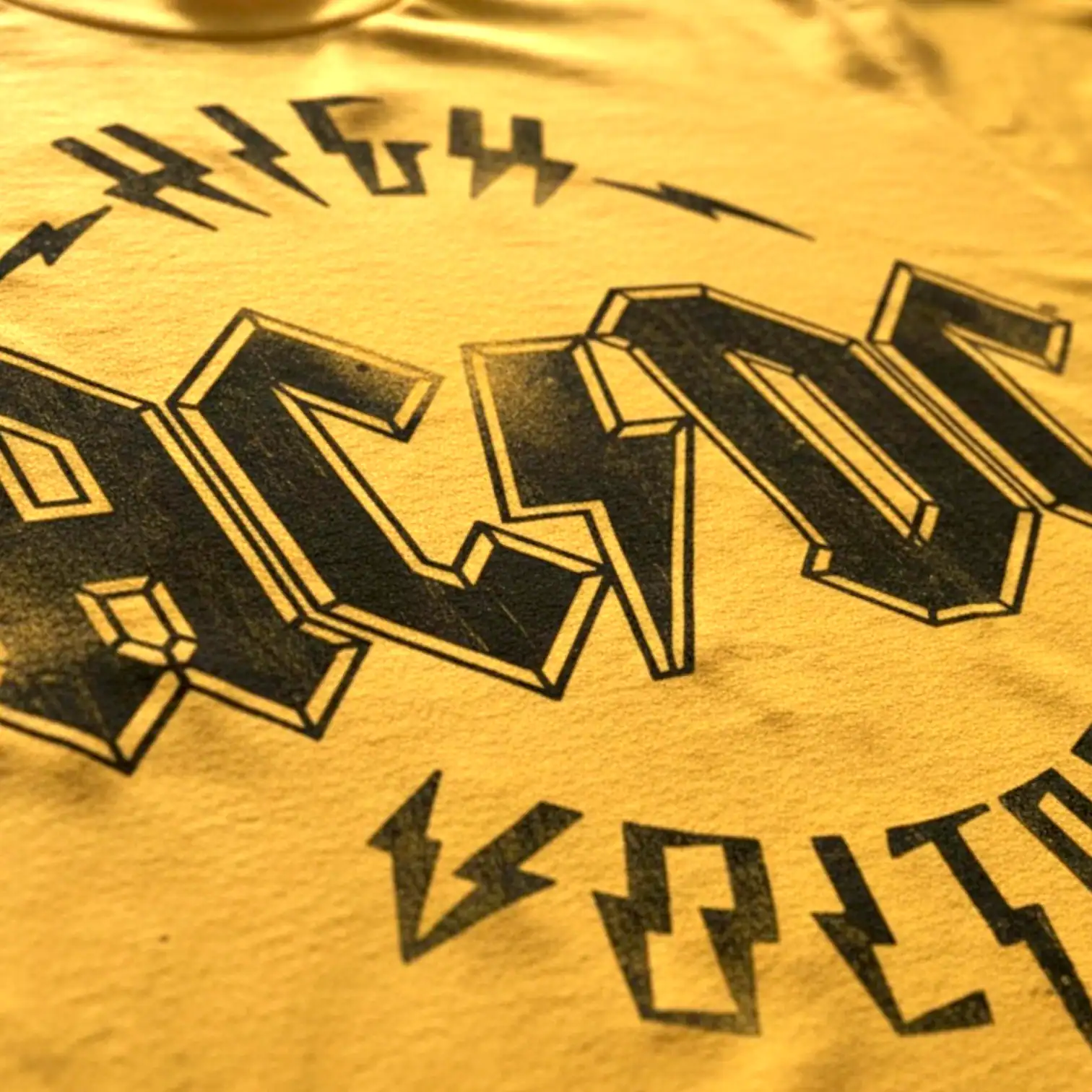Bold high voltage graphic on yellow T-shirt for a striking look.