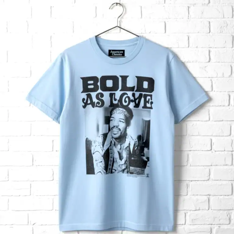 Light blue T-shirt featuring a bold "BOLD AS LOVE" graphic and artistic portrait print.