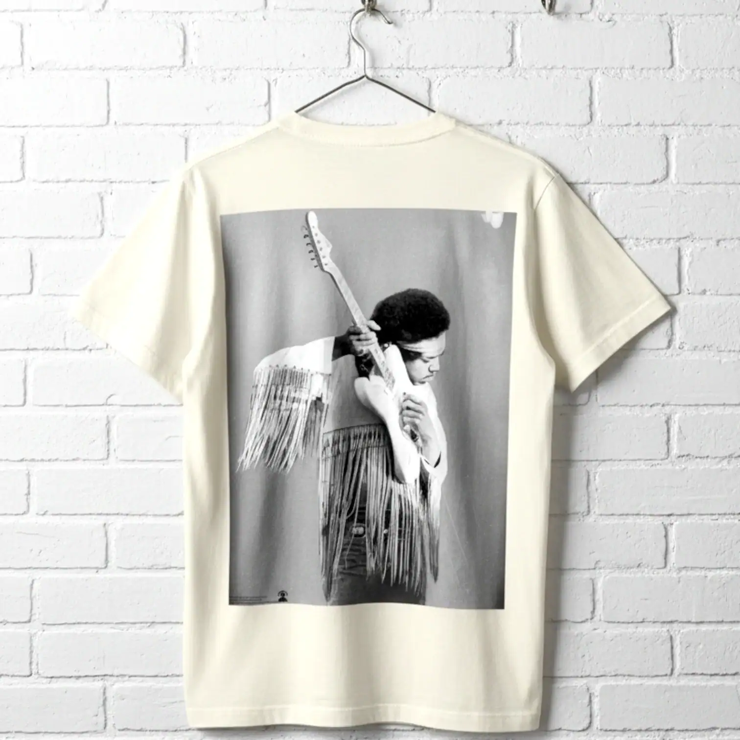 T-shirt featuring a black-and-white photo of a person with a guitar and fringe details.