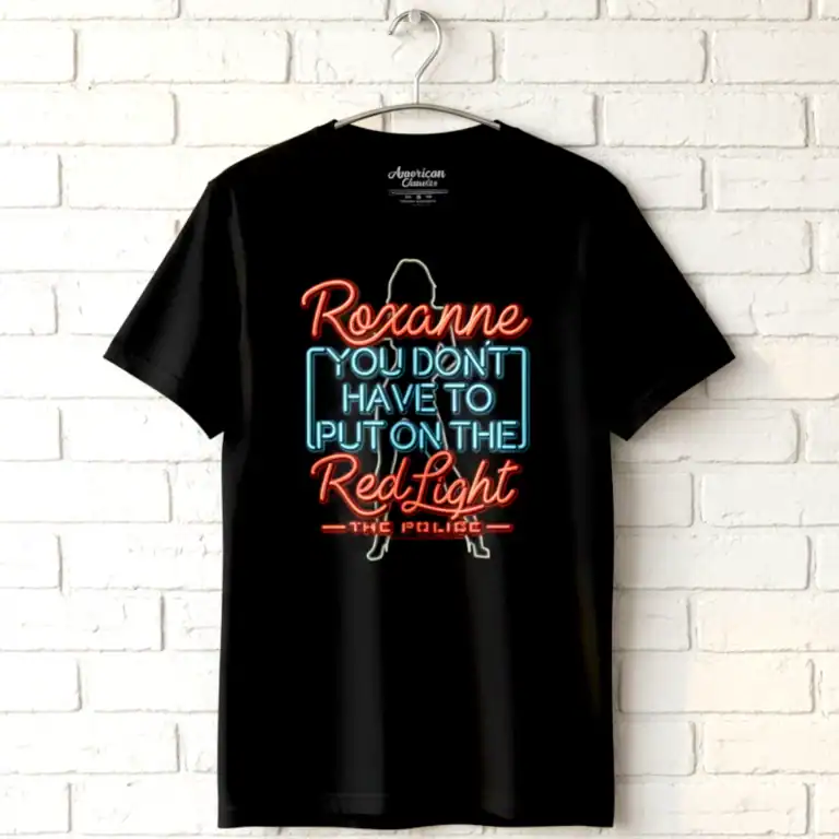Neon sign T-shirt with political message, black background, hanging on a white brick wall.