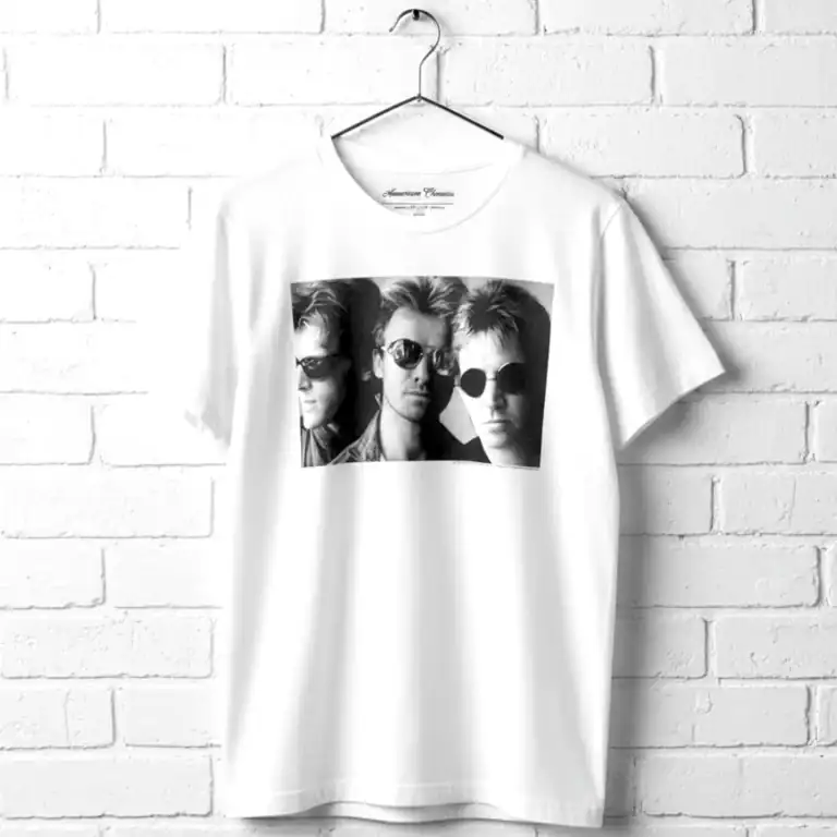 Classic band photo T-shirt featuring a black and white image of three musicians wearing sunglasses.
